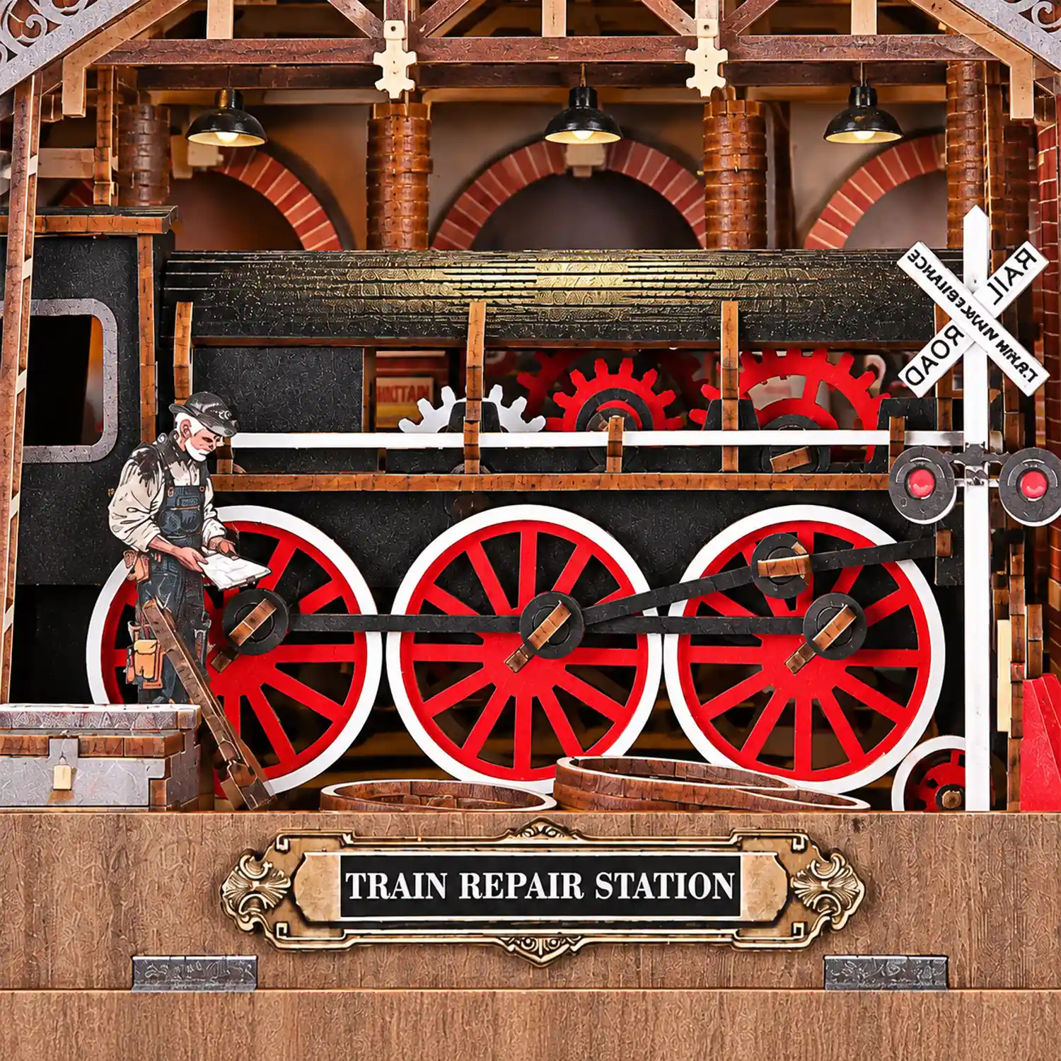 Stoomlocomotief met rode wielen in THAR Book Nook Train Repair Station
